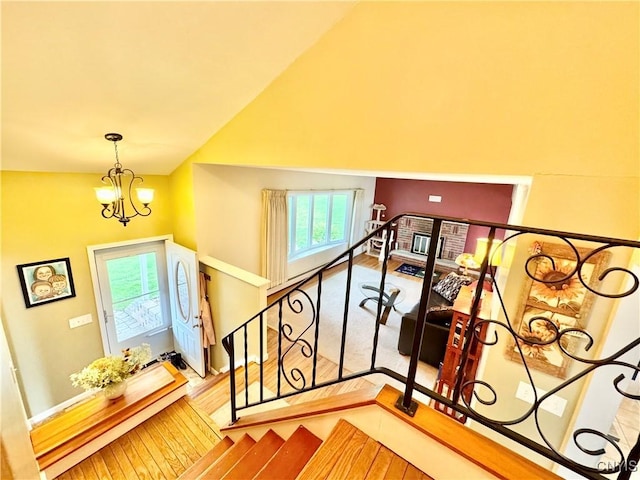 10 Litwak St, Fulton, NY 13069 - stairway with plenty of natural light, a chandelier, a baseboard radiator, lofted ceiling, and baseboards