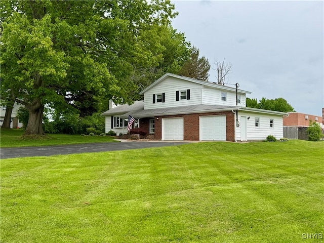 10 Litwak St, Fulton, NY 13069 - view of front of property with an attached garage, driveway, and brick siding