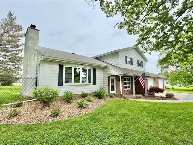 10 Litwak St, Fulton, NY 13069 - view of front of home featuring a garage, a chimney, concrete driveway, and brick siding