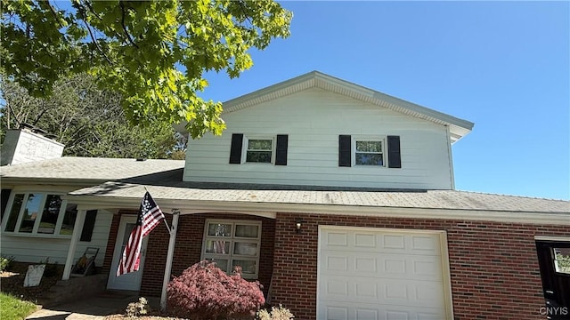 10 Litwak St, Fulton, NY 13069 - view of front of home featuring brick siding, a garage, roof with shingles, and covered porch