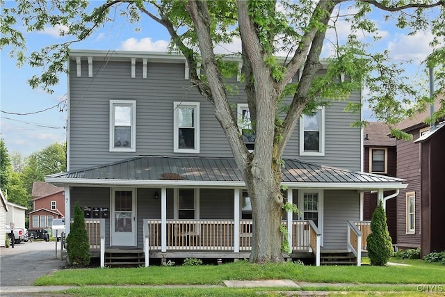 7-9 Tappan St Unit 7, Van Buren, NY 13027 - view of front facade featuring covered porch, metal roof, and a front lawn