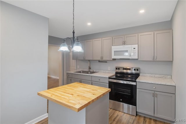 7-9 Tappan St Unit 7, Van Buren, NY 13027 - kitchen with white microwave, stainless steel electric range oven, a sink, gray cabinetry, and baseboards
