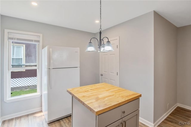 7-9 Tappan St Unit 7, Van Buren, NY 13027 - kitchen featuring freestanding refrigerator, butcher block countertops, a chandelier, light wood-style floors, and baseboards