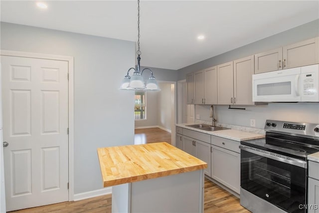 7-9 Tappan St Unit 7, Van Buren, NY 13027 - kitchen featuring white microwave, stainless steel range with electric stovetop, a sink, gray cabinetry, and a chandelier