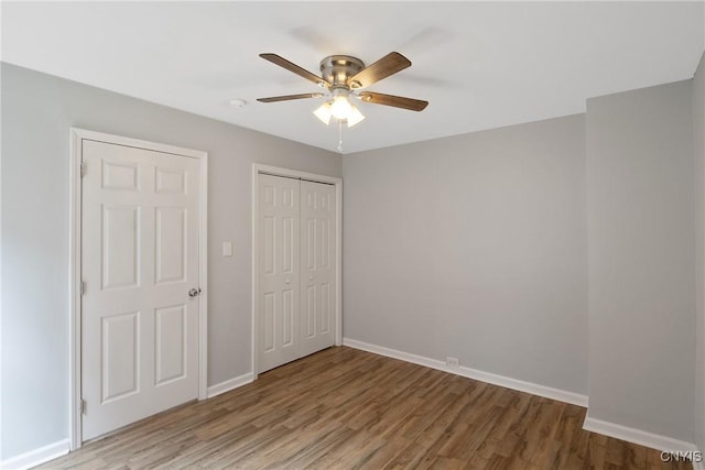 7-9 Tappan St Unit 7, Van Buren, NY 13027 - unfurnished bedroom featuring wood finished floors, a closet, baseboards, and a ceiling fan