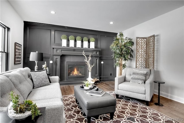 4 Streamsong Ct, Amherst, NY 14051 - living area featuring recessed lighting, wood finished floors, a glass covered fireplace, and baseboards