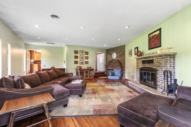 2260 Lamson Rd, Lysander, NY 13135 - living area featuring wood finished floors, a brick fireplace, and recessed lighting