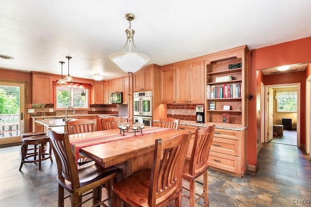 2260 Lamson Rd, Lysander, NY 13135 - dining space with dark stone finish flooring