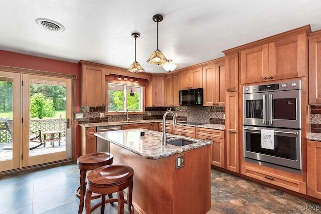 2260 Lamson Rd, Lysander, NY 13135 - kitchen featuring black appliances, a sink, brown cabinets, and tasteful backsplash