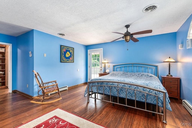 2260 Lamson Rd, Lysander, NY 13135 - bedroom featuring a baseboard radiator, wood finished floors, a textured ceiling, baseboards, and access to outside