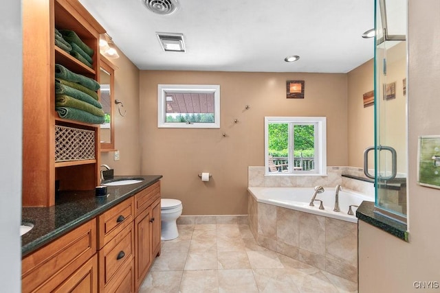 2260 Lamson Rd, Lysander, NY 13135 - bathroom featuring plenty of natural light, a garden tub, toilet, and double vanity