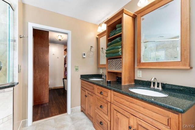 2260 Lamson Rd, Lysander, NY 13135 - bathroom featuring double vanity, baseboards, tile patterned floors, and a shower