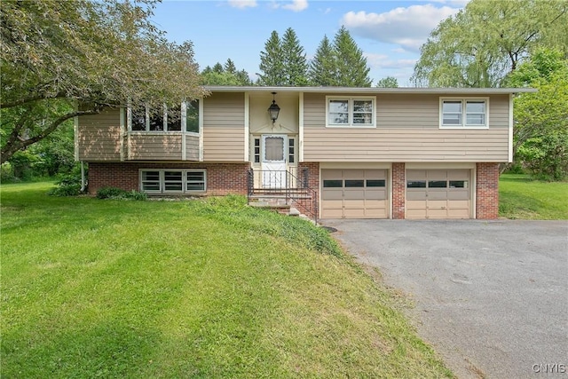 5682 Ike Dixon Rd, Camillus, NY 13031 - bi-level home featuring an attached garage, driveway, a front lawn, and brick siding