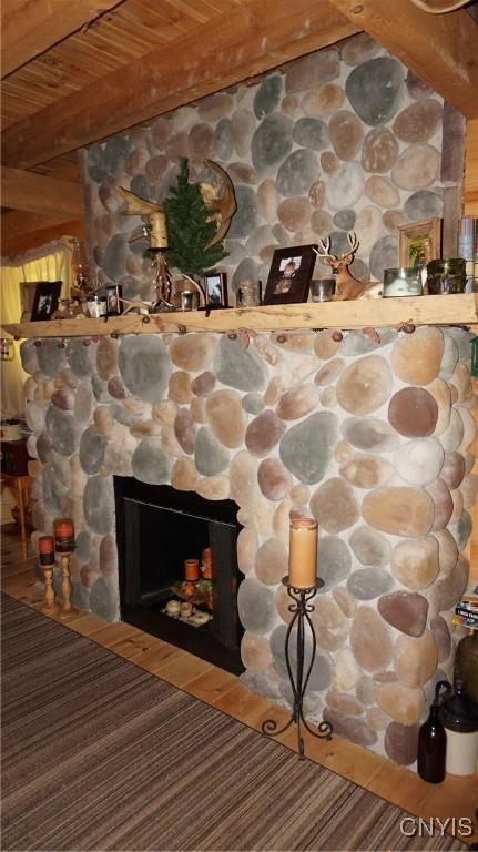 1507 Keeney Ln, Osceola, NY 13437 - detailed view of wood ceiling with exposed beams and a stone fireplace