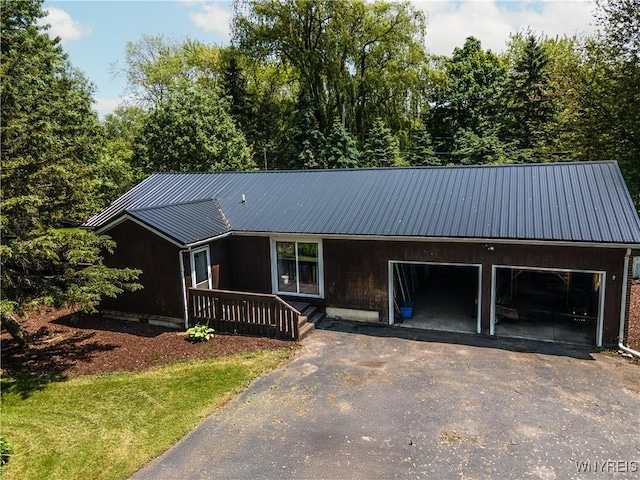 1763 Lake Rd, Porter, NY 14174 - view of front of property featuring driveway, metal roof, and an attached garage