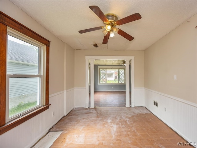2215 S Ave, Niagara Falls, NY 14305 - spare room with a wainscoted wall, ceiling fan, and light wood-style floors