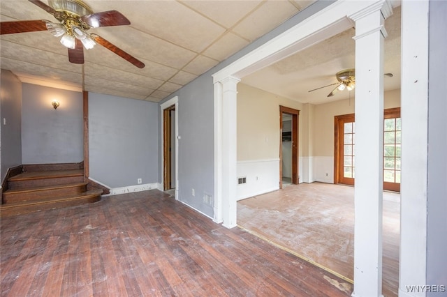 2215 S Ave, Niagara Falls, NY 14305 - spare room with ceiling fan, ornate columns, wood finished floors, baseboards, and stairway