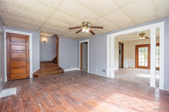 2215 S Ave, Niagara Falls, NY 14305 - unfurnished room with ceiling fan, ornate columns, wood finished floors, a paneled ceiling, and stairs