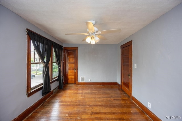 2215 S Ave, Niagara Falls, NY 14305 - unfurnished room featuring baseboards, hardwood / wood-style flooring, and a ceiling fan