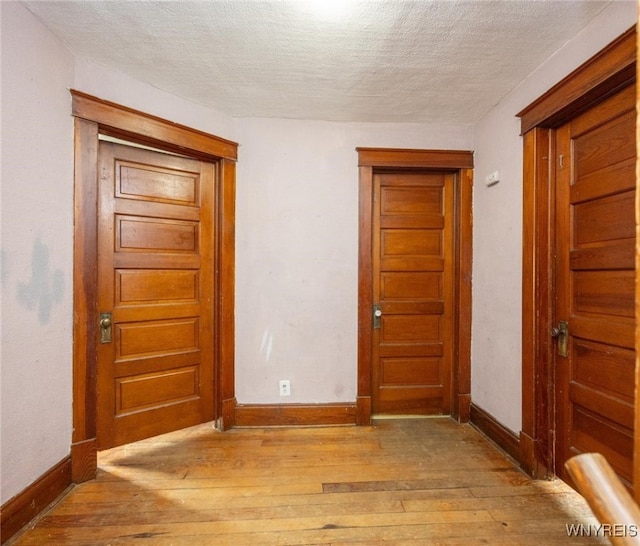 2215 S Ave, Niagara Falls, NY 14305 - spare room with light wood-style flooring, a textured ceiling, and baseboards