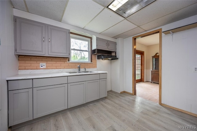 2215 S Ave, Niagara Falls, NY 14305 - kitchen with gray cabinets, a drop ceiling, a sink, light wood-type flooring, and light countertops