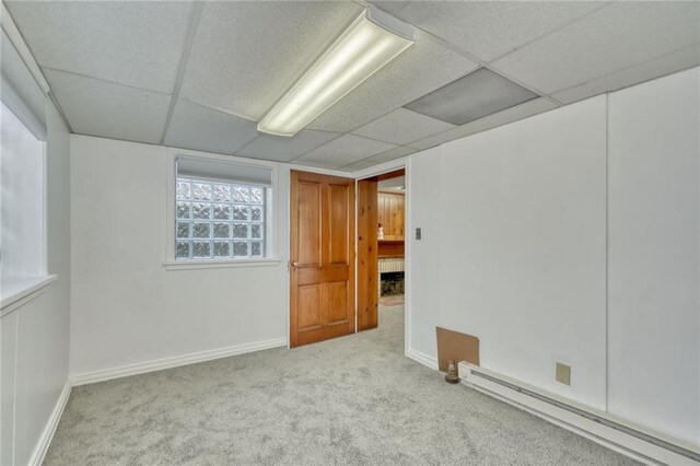 1845 N Clinton Ave, Rochester, NY 14621 - carpeted empty room with baseboard heating, a paneled ceiling, and baseboards