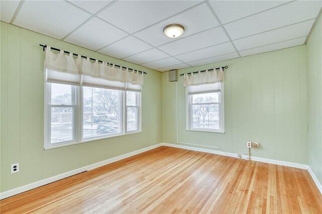 1845 N Clinton Ave, Rochester, NY 14621 - unfurnished room with wood finished floors, a drop ceiling, and baseboards