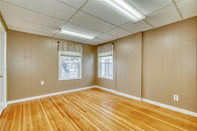 1845 N Clinton Ave, Rochester, NY 14621 - unfurnished room with light wood finished floors, a paneled ceiling, and baseboards