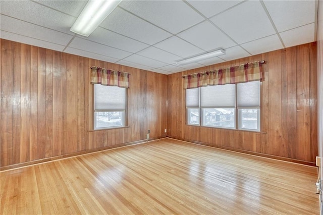1845 N Clinton Ave, Rochester, NY 14621 - spare room featuring wood finished floors, healthy amount of natural light, wooden walls, and a drop ceiling