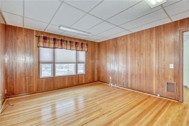 1845 N Clinton Ave, Rochester, NY 14621 - spare room featuring wood finished floors, wooden walls, and a paneled ceiling