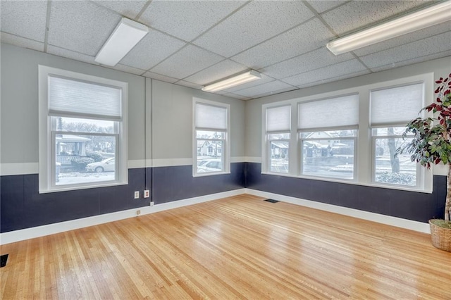 1845 N Clinton Ave, Rochester, NY 14621 - empty room featuring wood finished floors, baseboards, and a drop ceiling