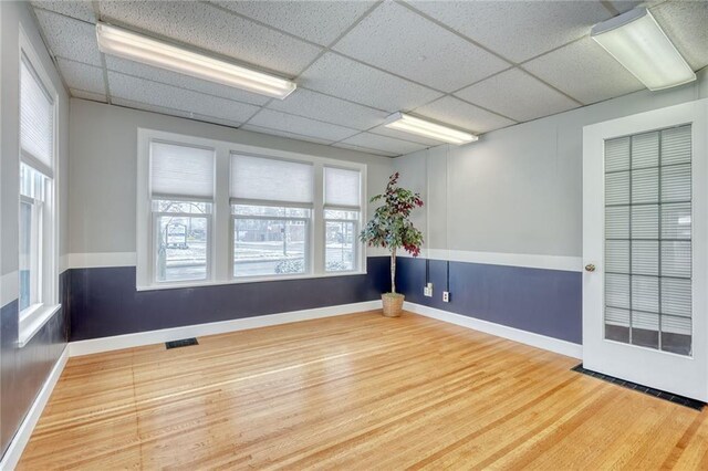 1845 N Clinton Ave, Rochester, NY 14621 - empty room with wood finished floors, a drop ceiling, and baseboards