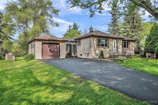 100 Brompton Rd, Amherst, NY 14221 - view of front of home featuring stone siding, an attached garage, asphalt driveway, a storage shed, and a front lawn
