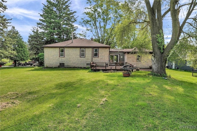 100 Brompton Rd, Amherst, NY 14221 - back of house featuring stone siding, a wooden deck, and a lawn