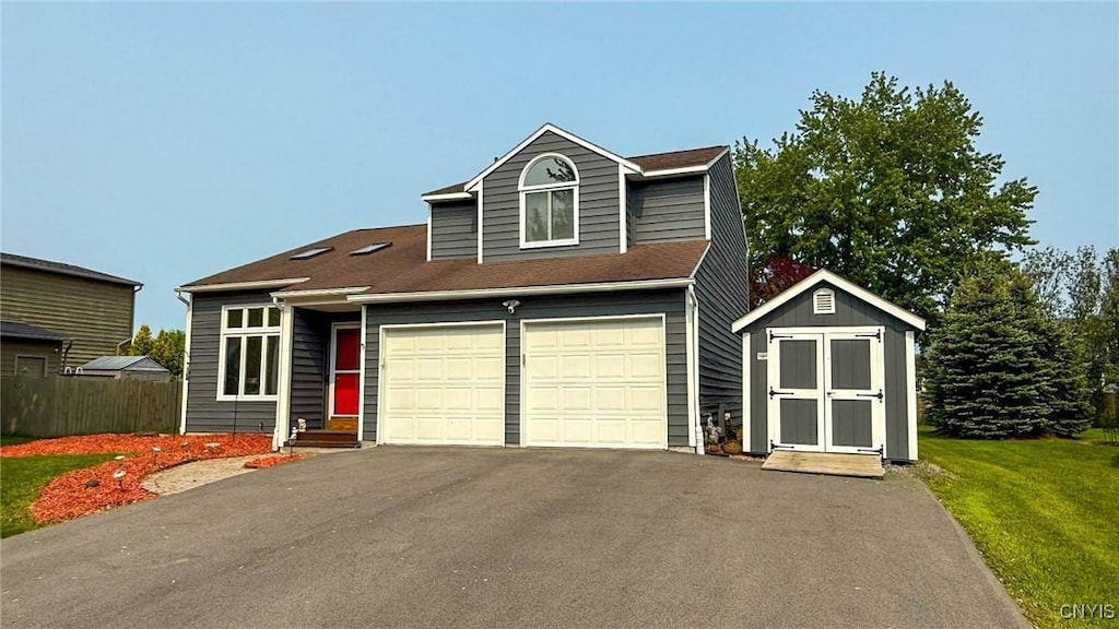 8602 Nazareth Dr, Cicero, NY 13039 - view of front facade with asphalt driveway, a storage shed, a front yard, and an attached garage