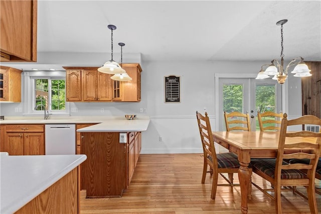 7425 State Route 20a, Bristol, NY 14469 - kitchen with white dishwasher, light wood-type flooring, brown cabinetry, glass insert cabinets, and plenty of natural light