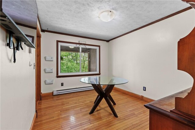 7425 State Route 20a, Bristol, NY 14469 - dining space with a baseboard heating unit, ornamental molding, a textured ceiling, light wood finished floors, and baseboards