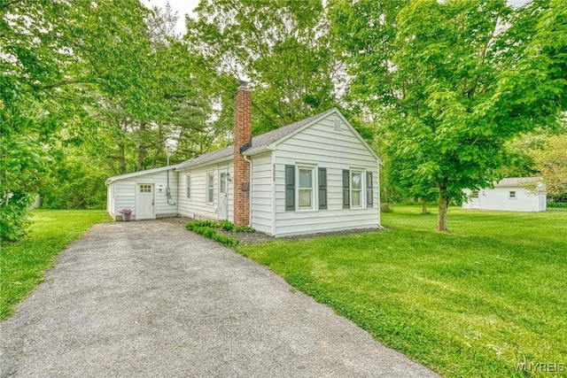 4356 Redman Rd, Sweden, NY 14420 - view of front of house with a chimney, a front lawn, view of scattered trees, and driveway