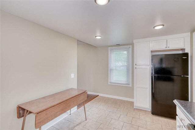 4356 Redman Rd, Sweden, NY 14420 - kitchen featuring freestanding refrigerator, white cabinets, and light tile patterned floors