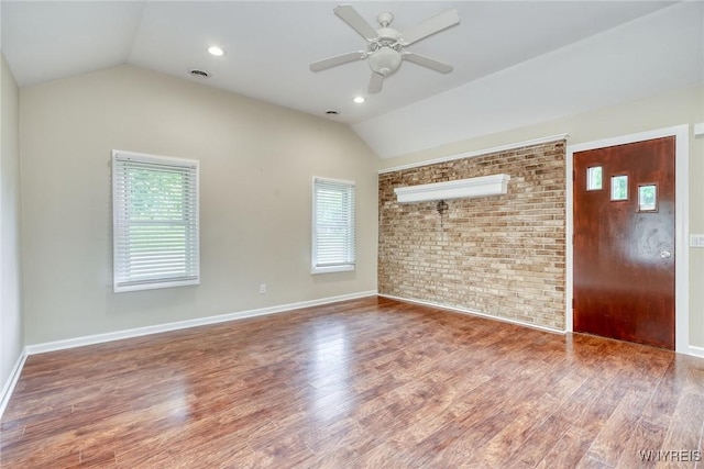 4356 Redman Rd, Sweden, NY 14420 - empty room featuring lofted ceiling, brick wall, a ceiling fan, and wood finished floors