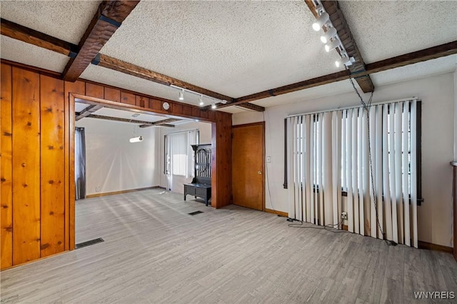 1934 Welch Ave, Niagara Falls, NY 14303 - basement featuring light wood-style floors, baseboards, rail lighting, and a textured ceiling