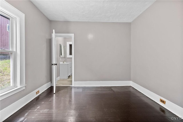 402 Cogswell Ave, Geddes, NY 13209 - unfurnished room with wood finished floors, baseboards, a textured ceiling, and a sink