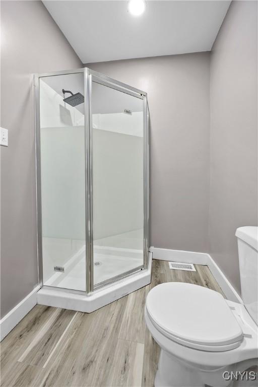 402 Cogswell Ave, Geddes, NY 13209 - bathroom with toilet, a stall shower, wood finished floors, baseboards, and recessed lighting