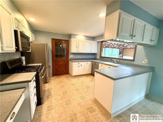 56 Otter St, Dunkirk-City, NY 14048 - kitchen featuring stainless steel appliances, a peninsula, tasteful backsplash, recessed lighting, and white cabinets