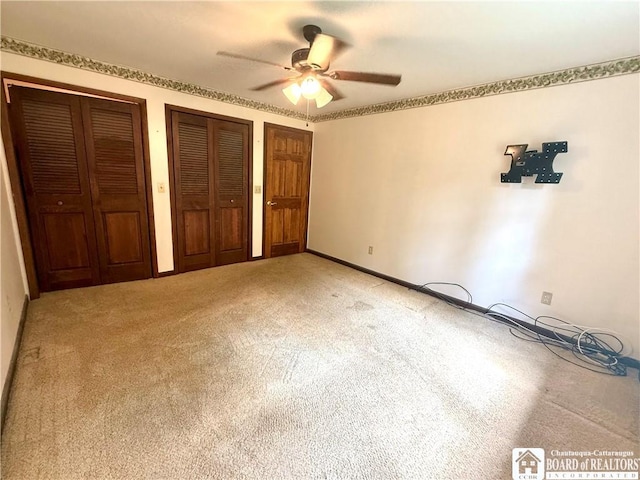 56 Otter St, Dunkirk-City, NY 14048 - unfurnished bedroom featuring two closets, light carpet, and a ceiling fan