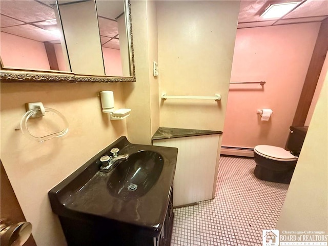 56 Otter St, Dunkirk-City, NY 14048 - bathroom with baseboard heating, vanity, and a paneled ceiling