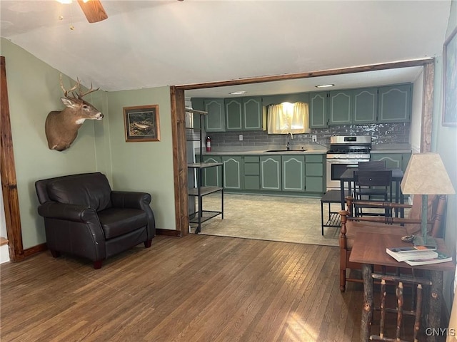 207 E Elm St, Oneida-Inside, NY 13421 - living room with wood finished floors, ceiling fan, and baseboards