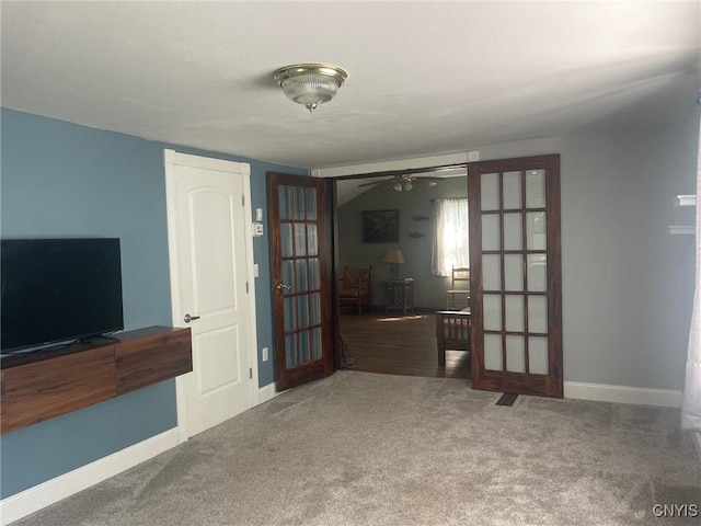 207 E Elm St, Oneida-Inside, NY 13421 - unfurnished living room featuring french doors, ceiling fan, carpet flooring, and baseboards