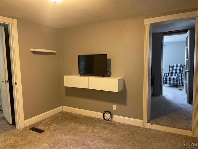 207 E Elm St, Oneida-Inside, NY 13421 - unfurnished living room featuring carpet floors and baseboards