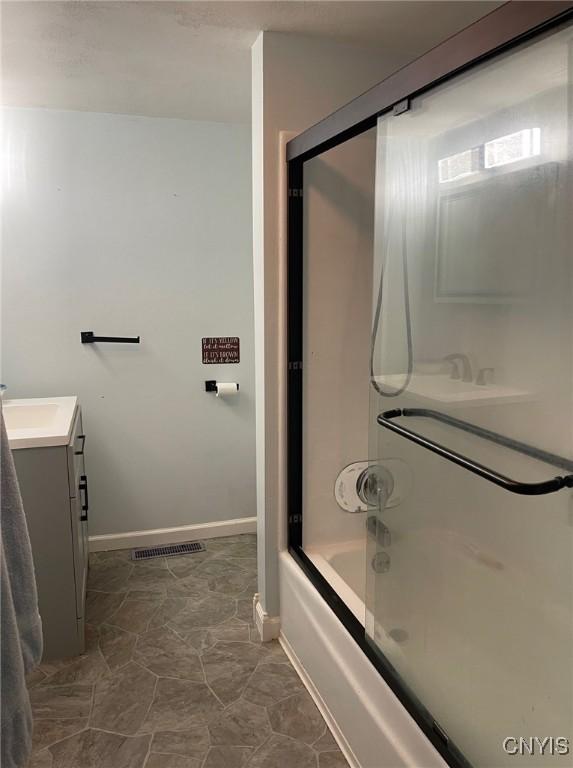 207 E Elm St, Oneida-Inside, NY 13421 - bathroom with vanity, shower / bath combination, and baseboards